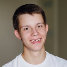 Preteen boy with missing front tooth smiling