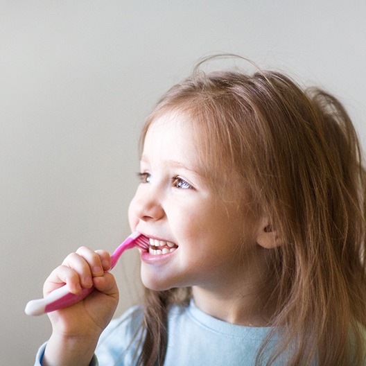 Closeup of child brushing her teeth