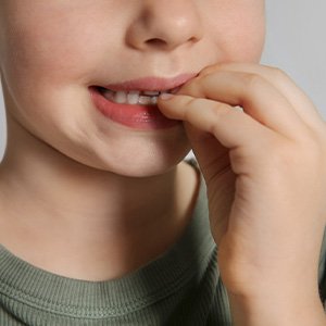 Closeup of child biting their nails