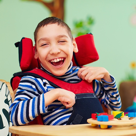 Laughing child in wheelchair