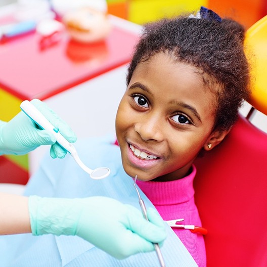 A young girl having her teeth examined while visiting a children’s dentist in Palm Harbor