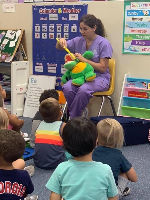 Dental team member Brittany visiting school kids for oral health education