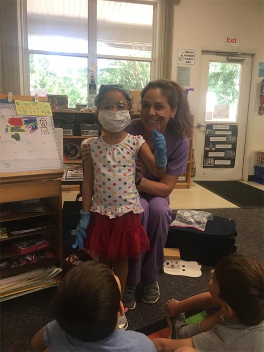 Dental team member teaching kids about dentistry