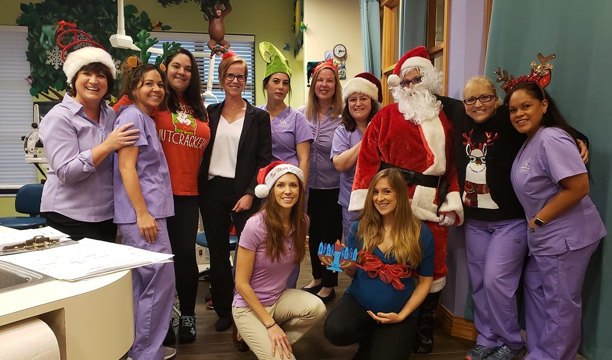 Dental team wearing festive holiday outfits