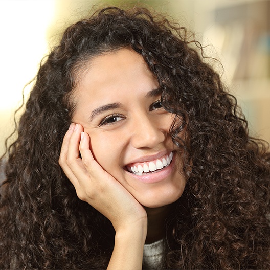 Woman sharing smile after dental crown restoration