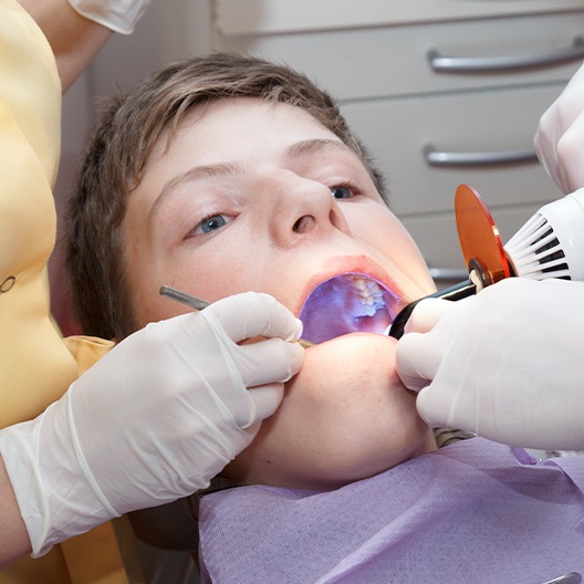 Child receiving dental bonding treatment