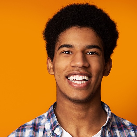 Teen boy sharing smile after teeth whitening treatment