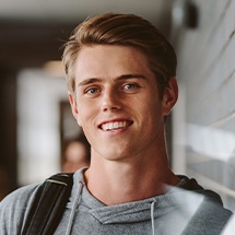 Young man smiling after repairing chipped tooth