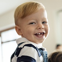 Child with missing front tooth smiling