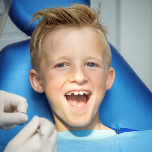 Child smiling during tooth extraction appointment