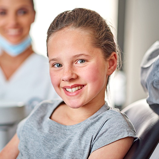 Smiling girl after tooth extraction