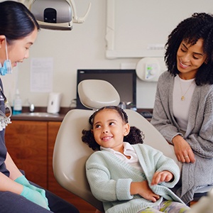 Mother and child speaking to dental team member
