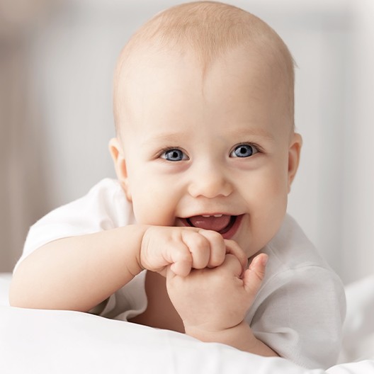 Smiling baby with lip ties