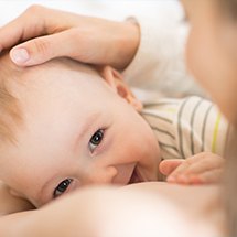 Mother holding smiling baby