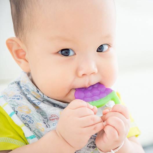 Baby chewing on teething toy