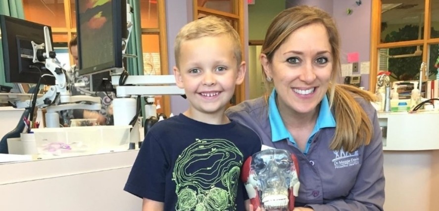 Doctor Lorielle and young dental patient