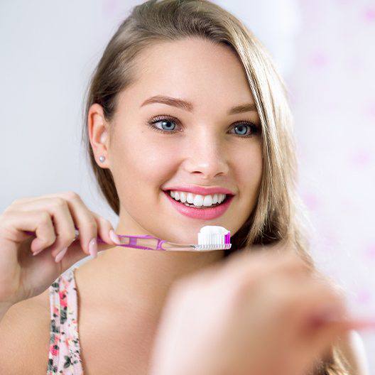 Teenage girl brushing her teeth in Palm Harbor