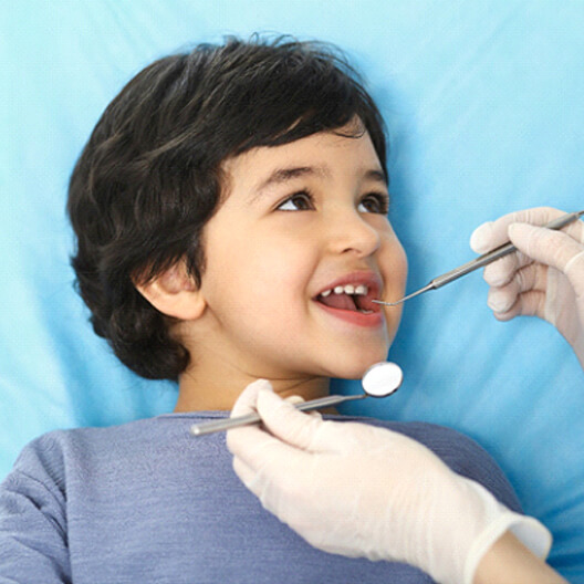 A little boy having his teeth checked during a dental checkup
