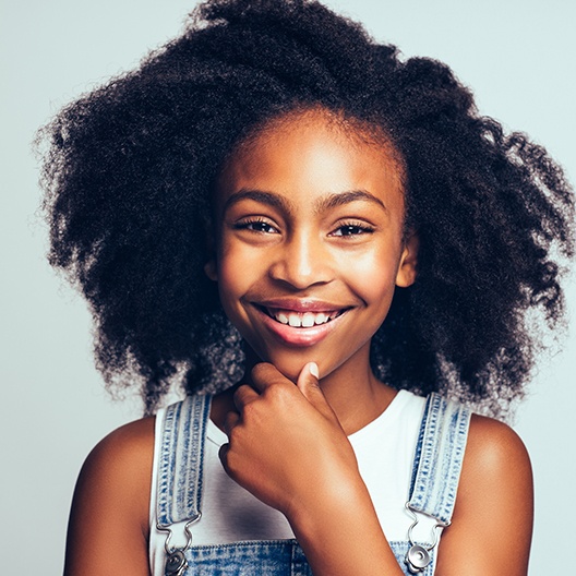 Young girl smiling after silver diamine Florida treatment