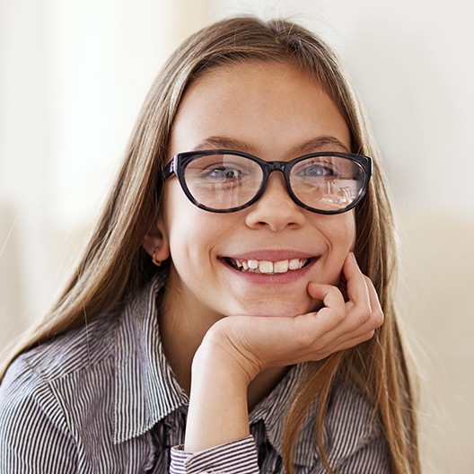 Young girl smiling after pulp therapy