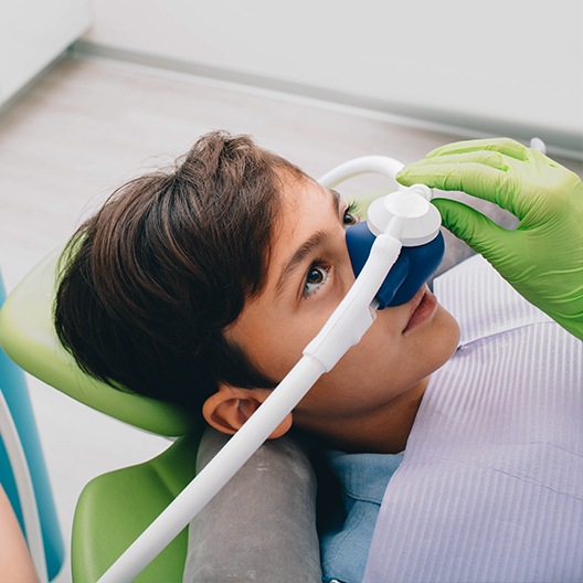 Young boy with nitrous oxide nose mask in place