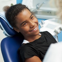 Smiling preteen girl at preventive dental checkup