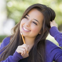 Teen girl smiling after cosmetic dentistry treatment