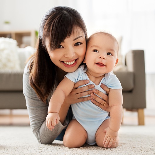 Woman holding up an infant