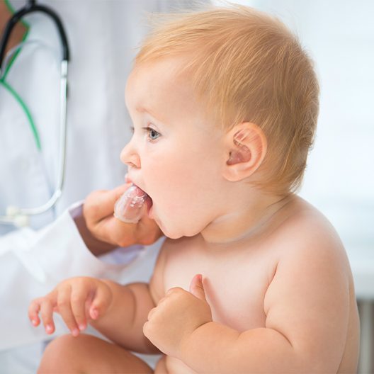 Dentist checking an infant's teeth