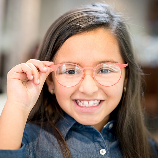 Child with glasses smiling