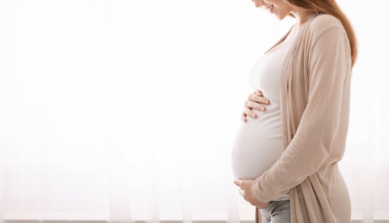 a pregnant woman holding her belly