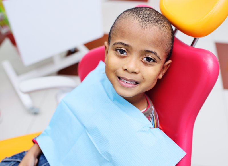 A child sitting in a dentist's chair