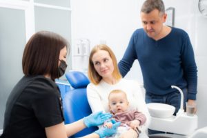 mom holding the baby for the child’s first dental visit