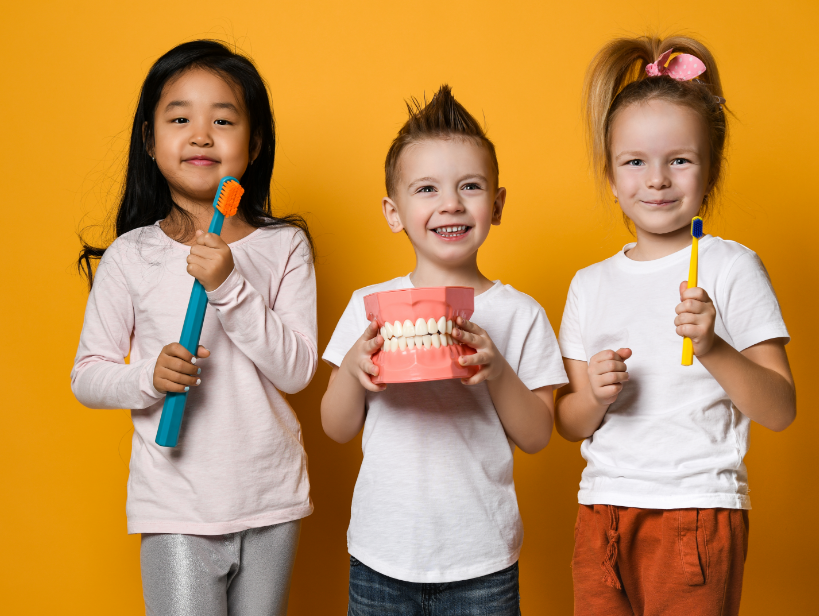 Kids holding toothbrushes