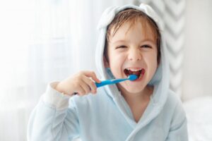 Little boy brushing teeth.