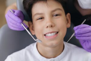 Teen at their pediatric dentist smiling